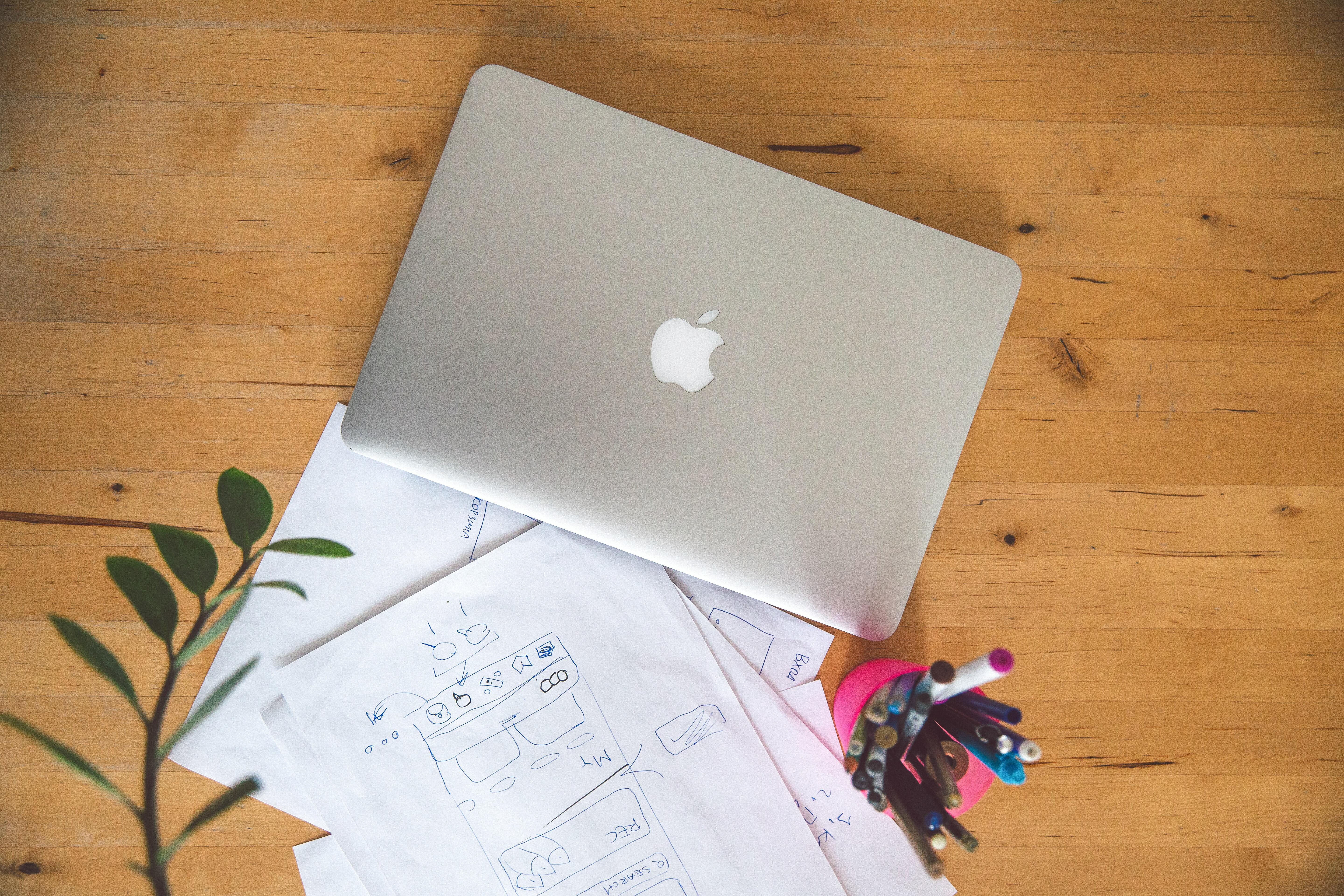 apple MacBook Air on coffee table with papers