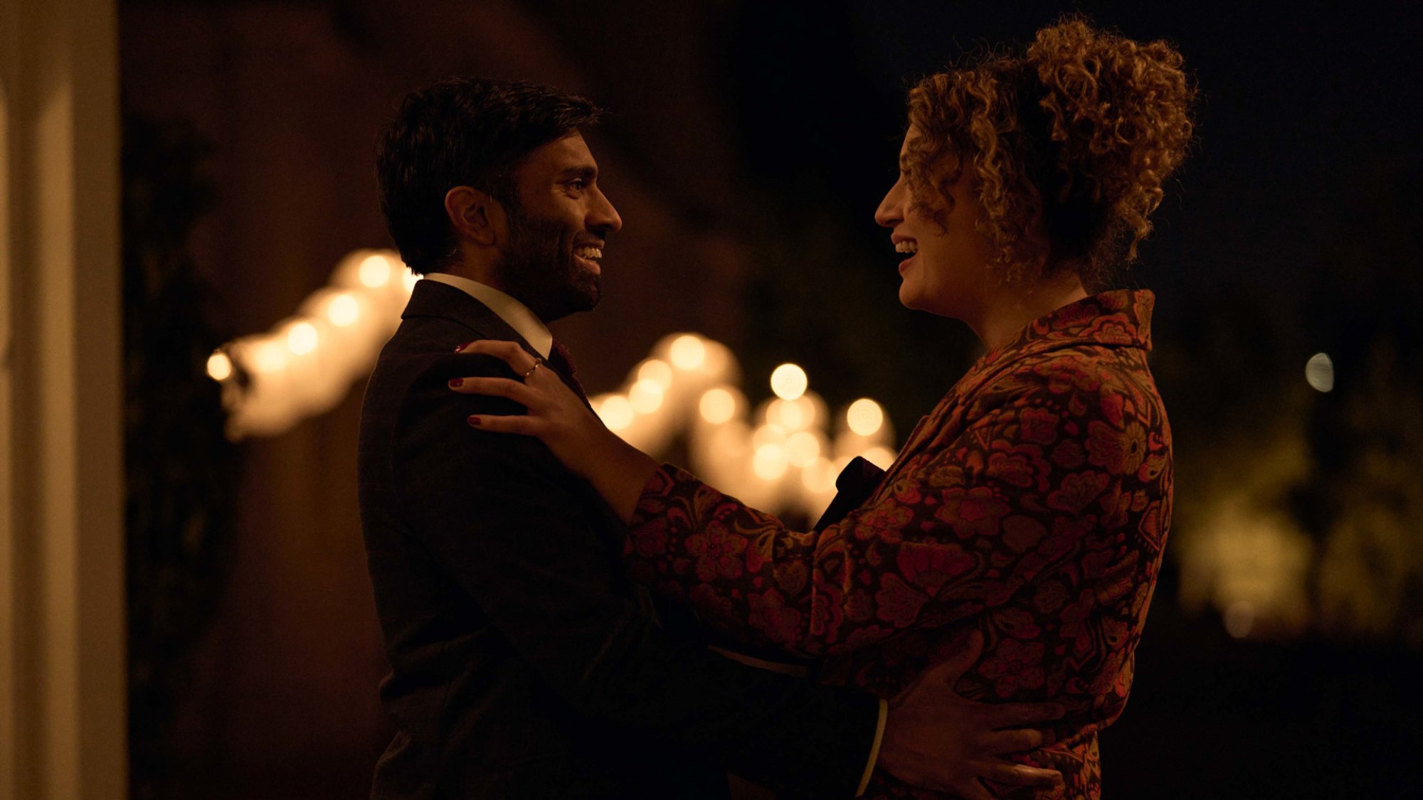 Jessie (Matafeo) and Tom (Nikesh Patel) embrace each other at a wedding in the TV show "Starstruck"