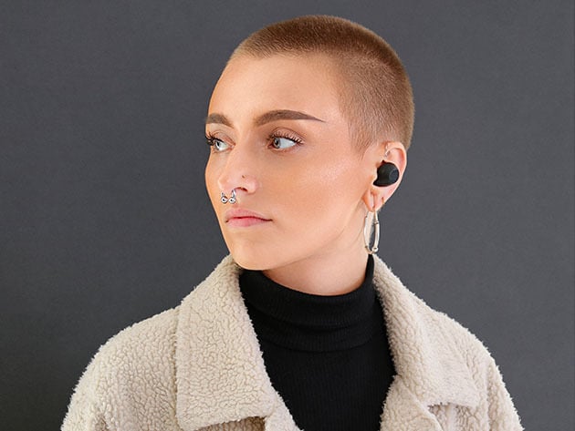 Woman wearing translation earbuds.