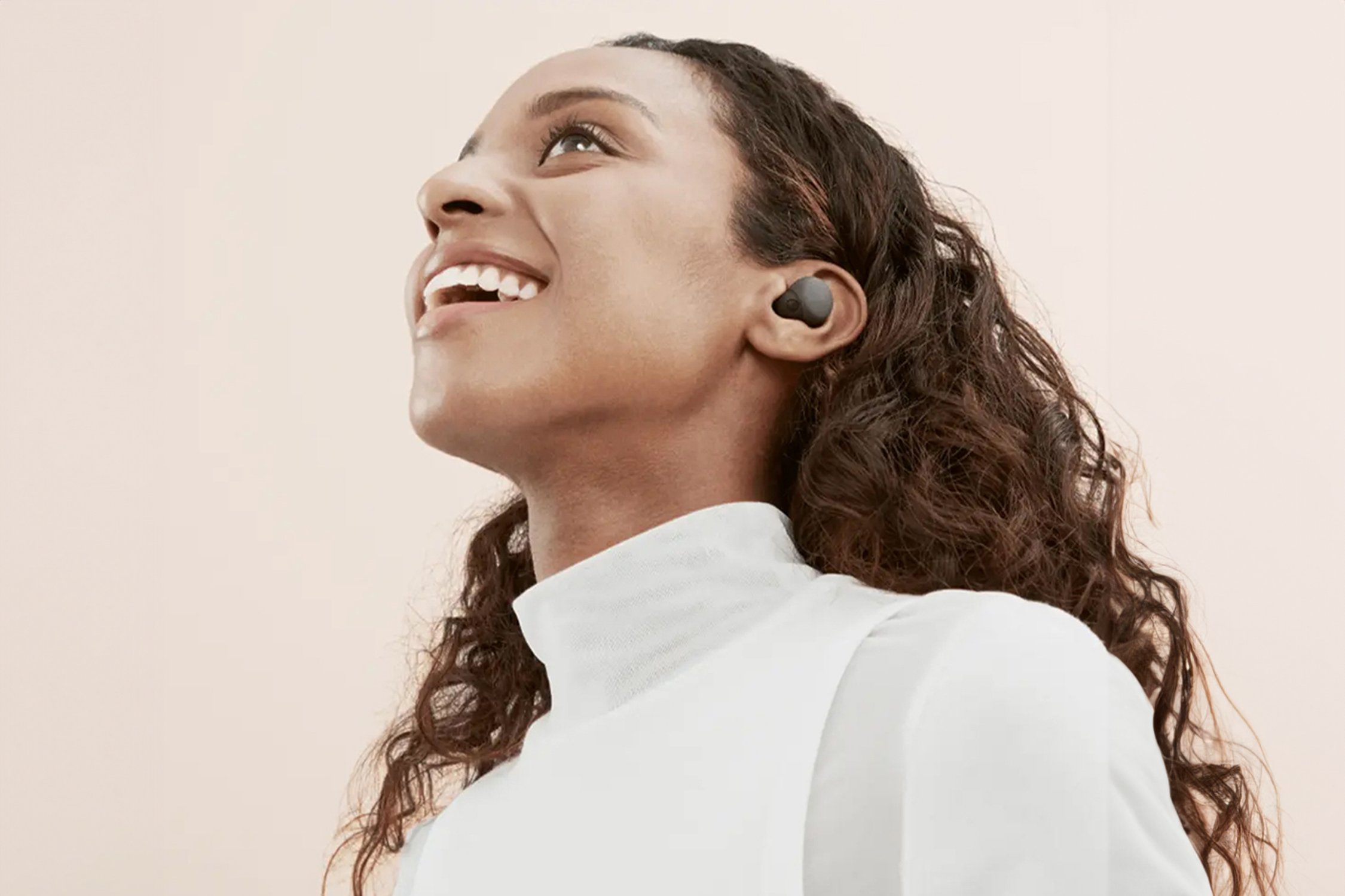 Woman wearing earbuds.