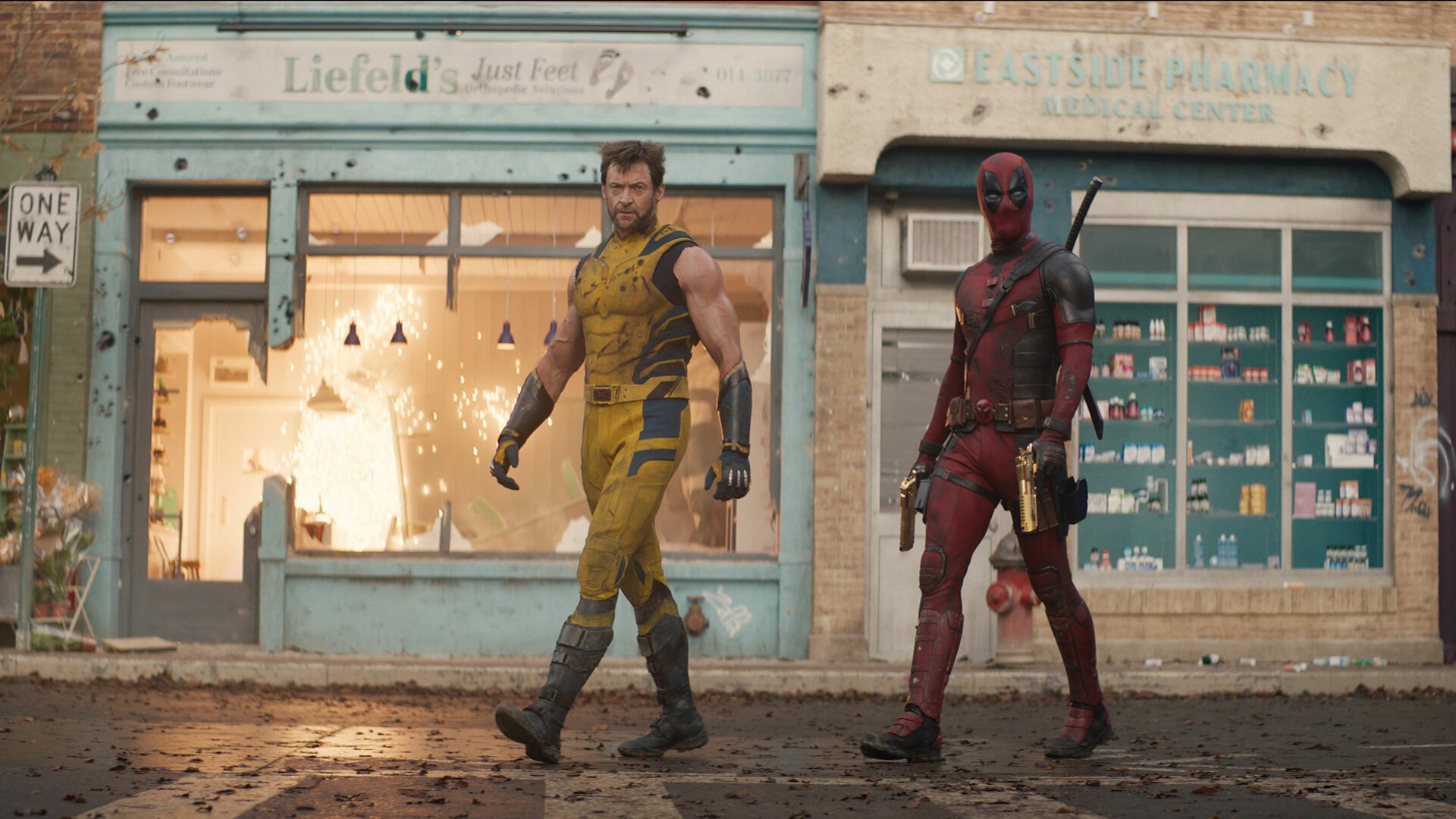 Two superheroes walk side by side on a street.