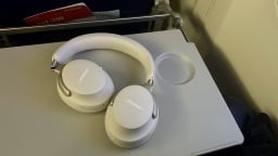 white bose quietcomfort ultra headphones on airplane tray 
