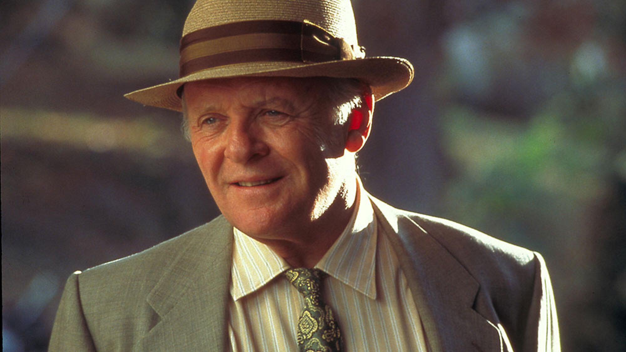 A man in a fedora, suit, and tie.