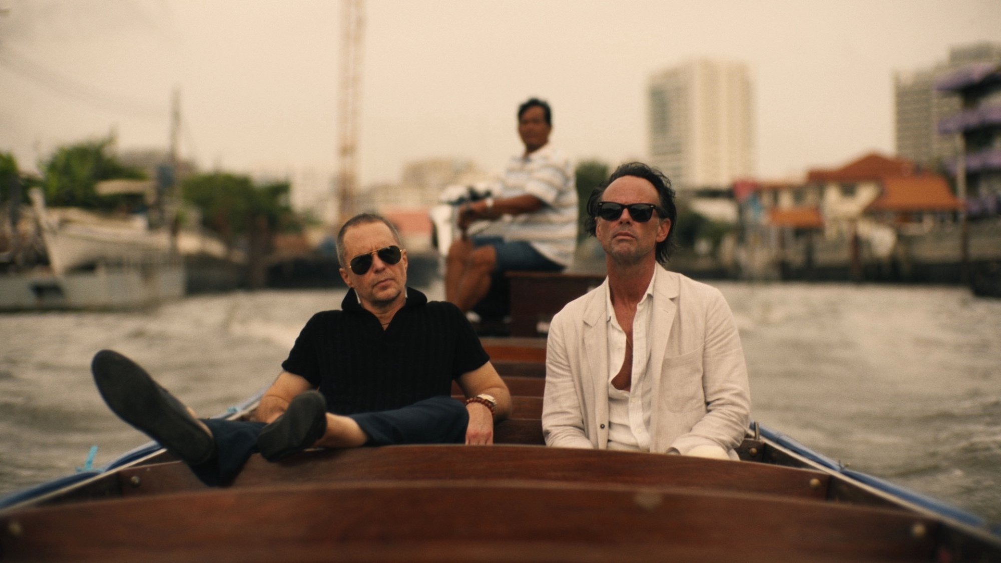 Sam Rockwell and Walton Goggins sit in a boat in "The White Lotus."