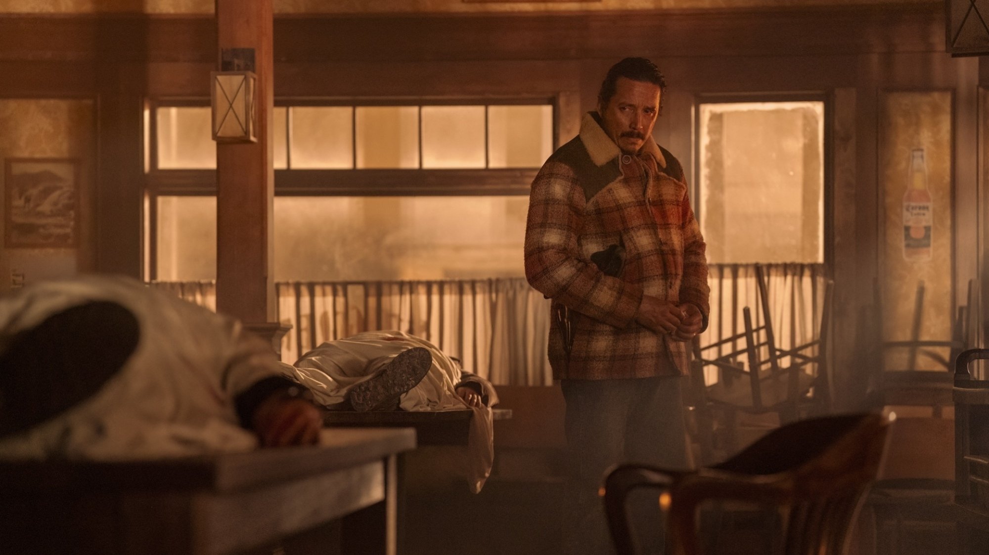 Gabriel Luna stands in a makeshift morgue as Tommy in "The Last of Us."