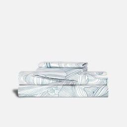 a set of Brooklinen sheets stacked above each other