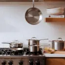 A collection of Made In cookware on a stove