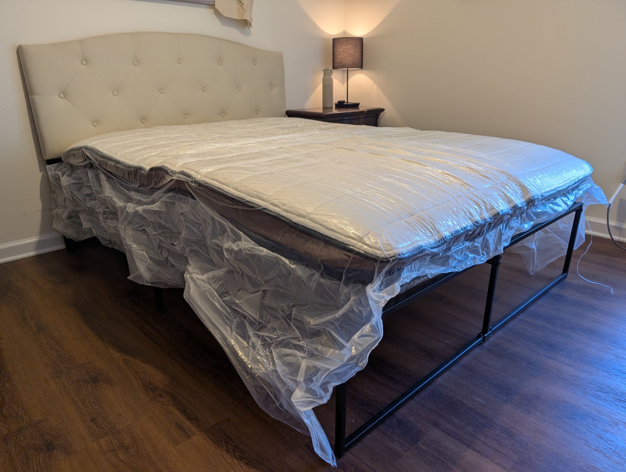 the brooklyn bedding copperflex pro mattress in plastic on a bed frame