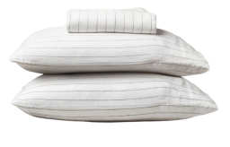 a stack of pillows and sheets in a pinstripe