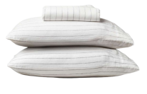 a stack of pillows and sheets in a pinstripe