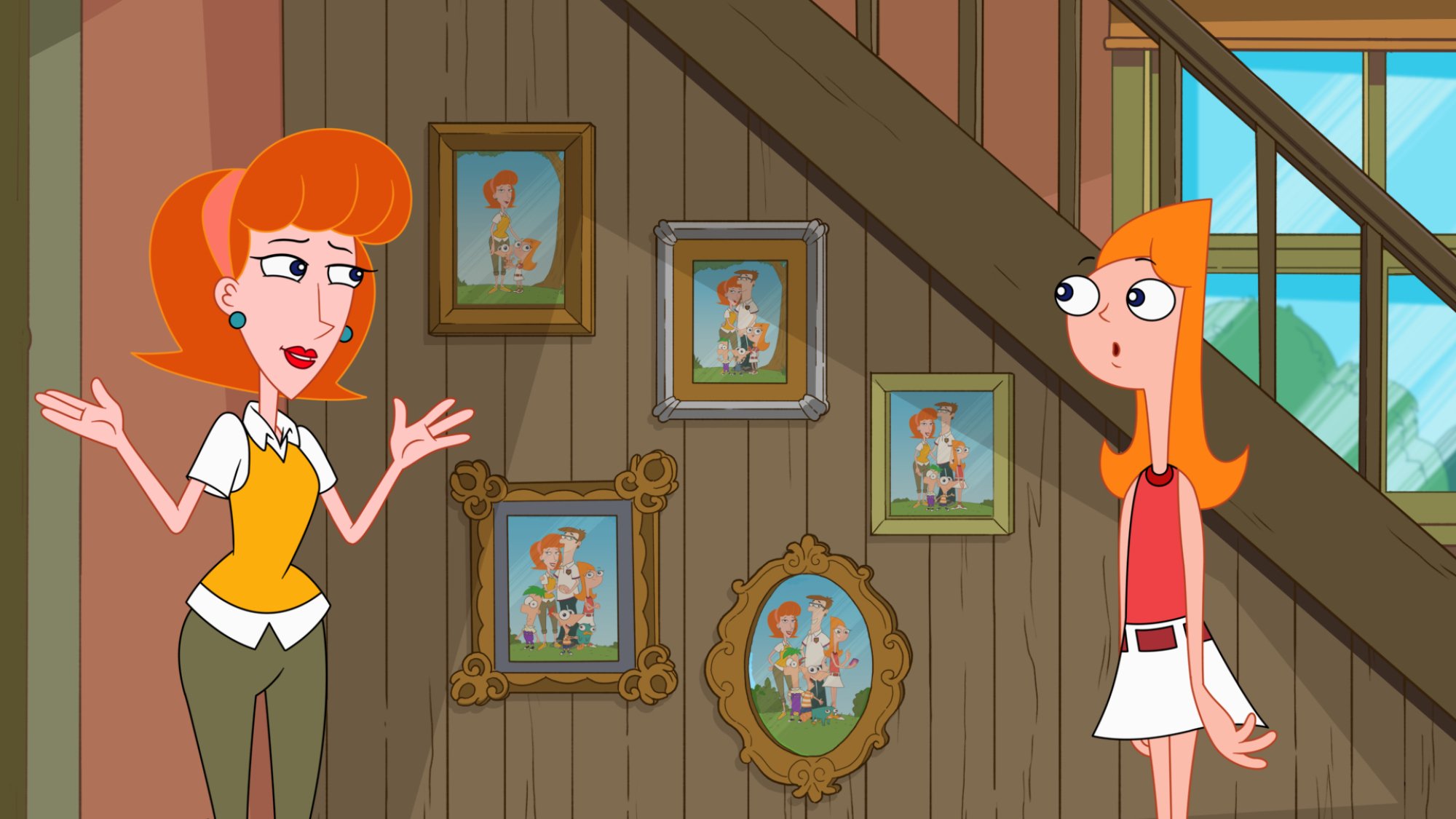 Candace and her mom talk in front of a wall of family photos.