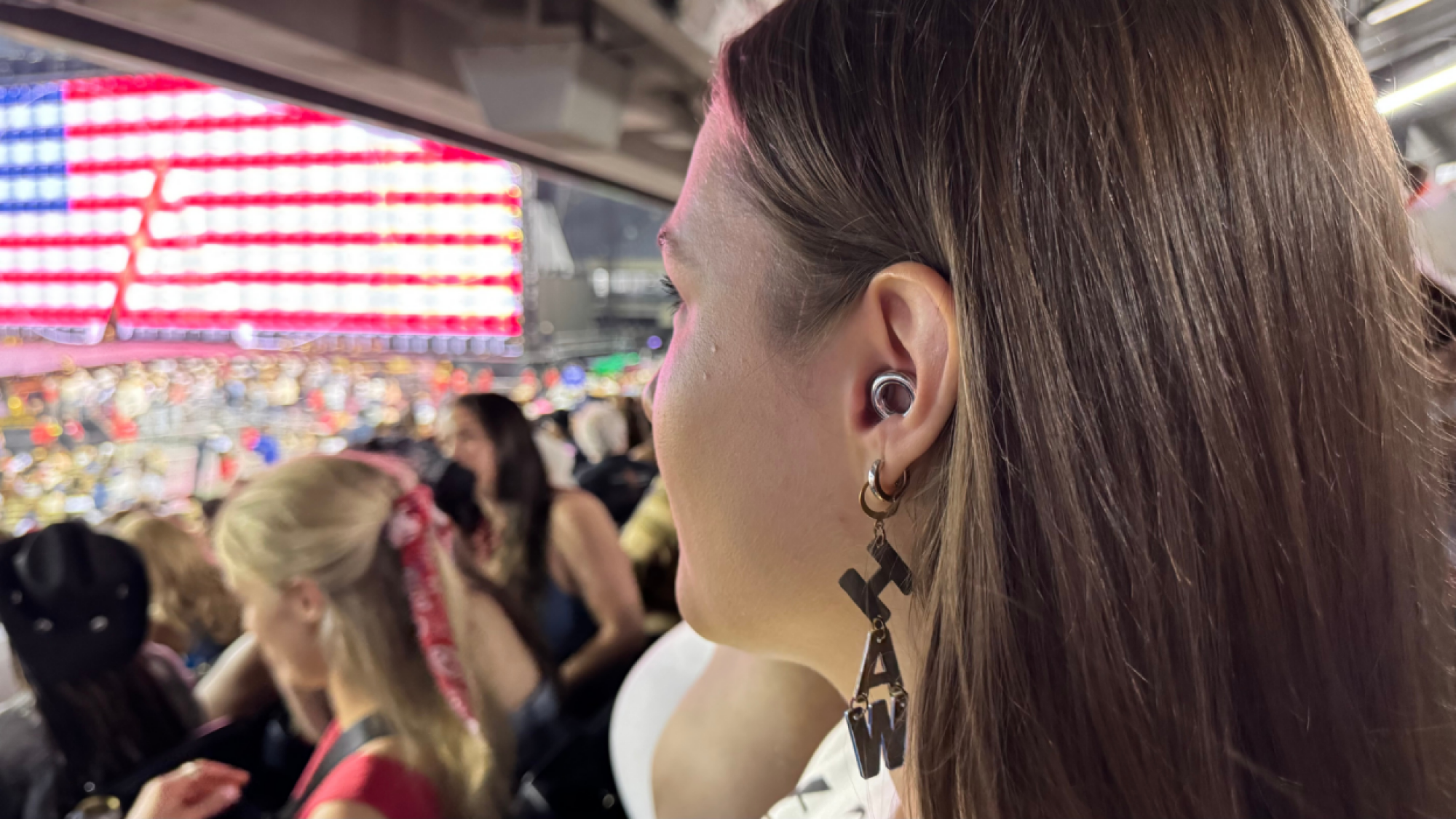 a woman wearing loop experience 2 earplugs at the cowboy carter tour