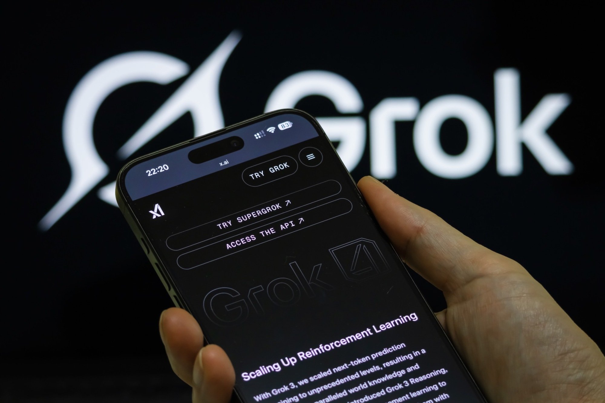 a person holds a smartphone showing the Grok 4 introduction page